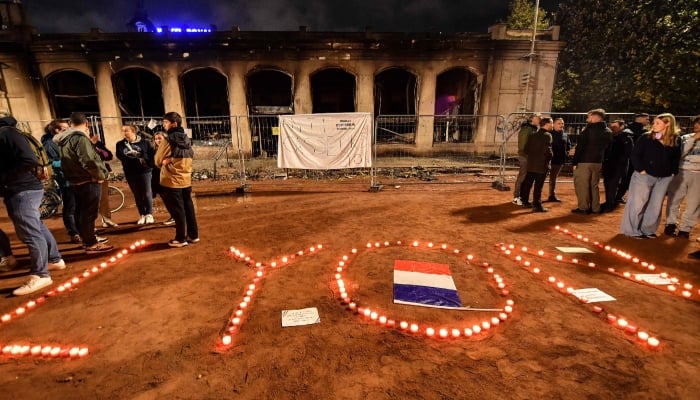 People lit candles in front of the Lyon tourist office before a partial curfew in Lyon, France, October 19, 2026. — AFP