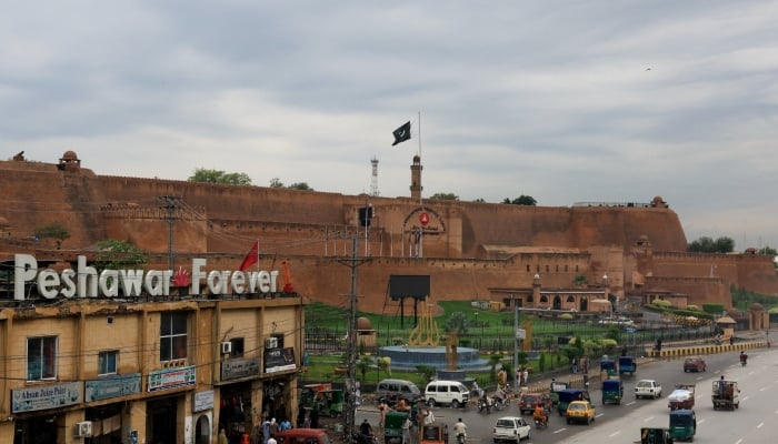 Traffic moves past Bala Hisar Fort, which serves as the headquarters of Pakistans Frontier Corps, in the background in Peshawar, October 13, 2026. — Reuters