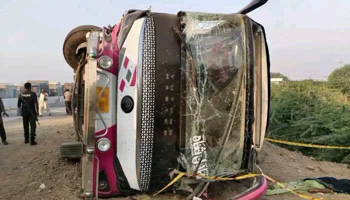 A passenger bus lies overturned on the Indus Highway in Rajanpur after an accident on October 21, 2026. — Screengrab via Geo News