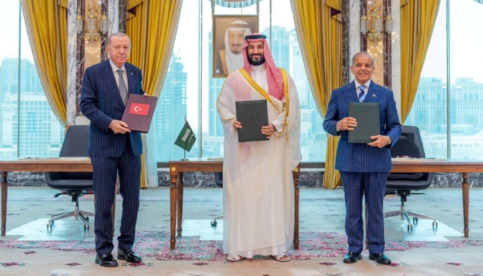 Turkish President Tayyip Erdogan, Saudi Crown Prince Mohammed bin Salman, and Prime Minister Shehbaz Sharif pose after signing a joint defence agreement in Makkah, Saudi Arabia, August 7, 2026. — Reuters