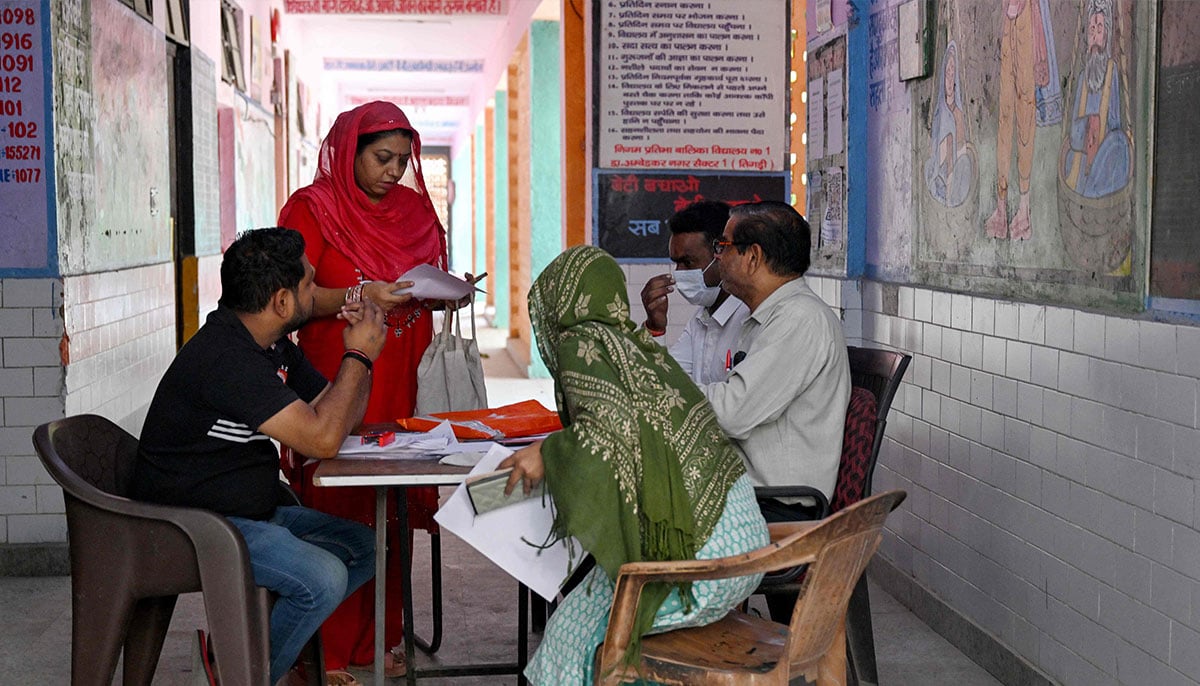 Indians struggle to prove voting eligibility amid voter roll revision 19 Booth level-officer (BLO) Mukesh Khanna (R) assists people to register their documents for the Draft Electoral Roll 2026 as part of the Election Commission of Indias Special Intensive Revision (SIR), at a voter verification camp in New Delhi on October 18, 2026. — AFP