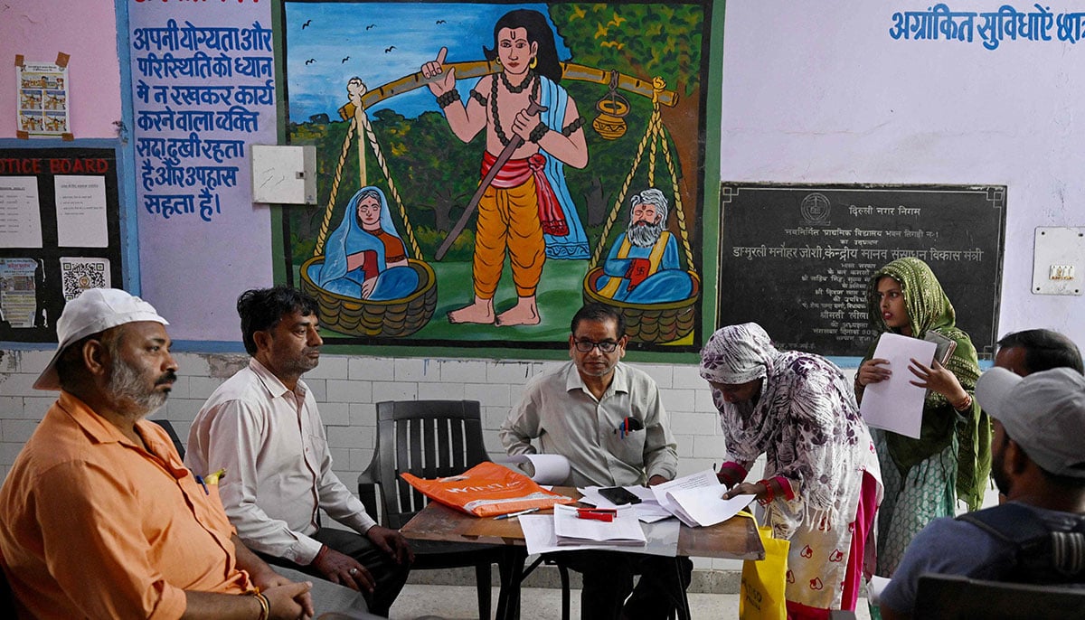 Indians struggle to prove voting eligibility amid voter roll revision 18 Booth level-officer (BLO) Mukesh Khanna (3L) assists Laddli Khatun (3R), a slum dweller to register for the Draft Electoral Roll 2026 as part of the Election Commission of Indias Special Intensive Revision (SIR), at a voter verification camp in New Delhi on October 18, 2026. — AFP