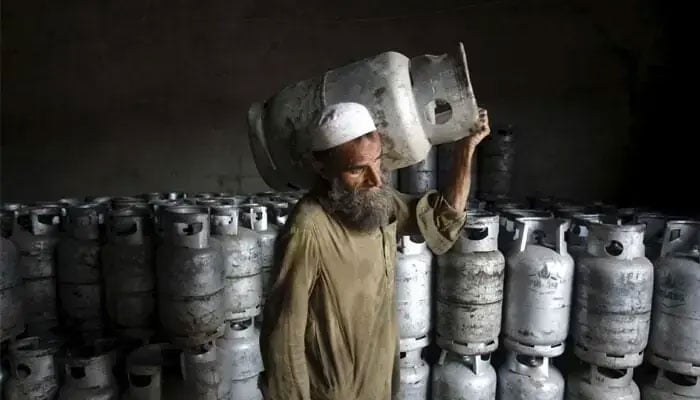 A man carries an LPG cylinder in this file photo. — Reuters