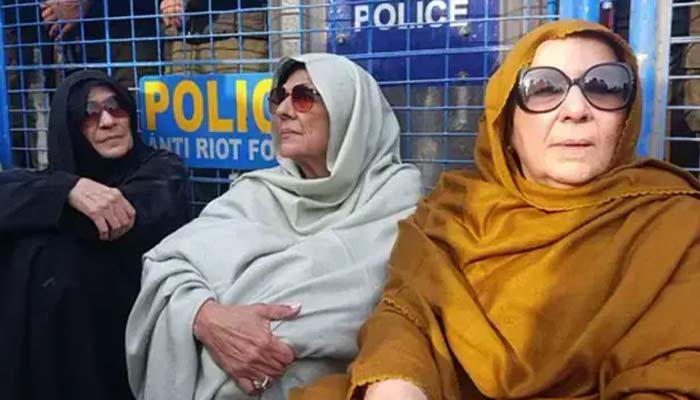 From left — Dr Uzma Khan, Aleema Khan and Noreen Niazi, sisters of PTI founder Imran Khan, sit in front of a police barricade in Rawalpindi on December 9, 2025. — X/@PTIofficial/