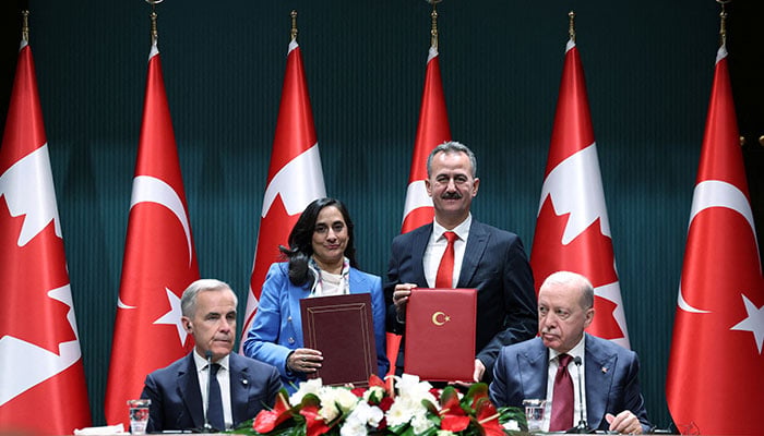 Secretary of Turkish Defence Industries Haluk Gorgun and Canadian Foreign Minister Anita Anand, with Turkish President Tayyip Erdogan and Canadian Prime Minister Mark Carney in the foreground, attend a signing ceremony at the presidential palace in Ankara, Turkiye, October 22, 2026. — Reuters