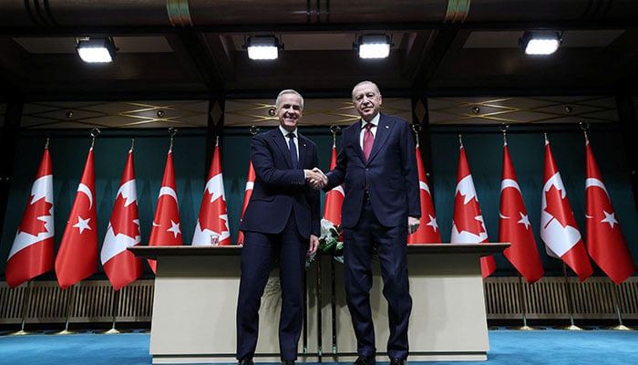 Turkish President Tayyip Erdogan and Canadian Prime Minister Mark Carney shake hands during a press conference at the presidential palace in Ankara, Turkiye, October 22, 2026. — Reuters