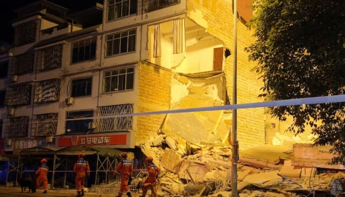 Rescue workers walk past a damaged building following an earthquake at Taiyang village in Liuzhou, Guangxi Zhuang Autonomous Region, China May 18, 2026. — Reuters