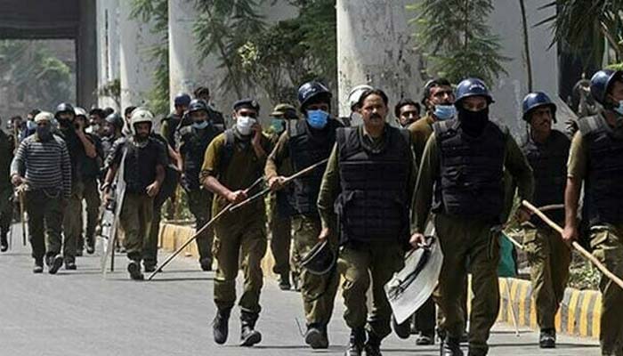 Policemen arrive at the site of a protest during a demonstration in Lahore. — AFP/File