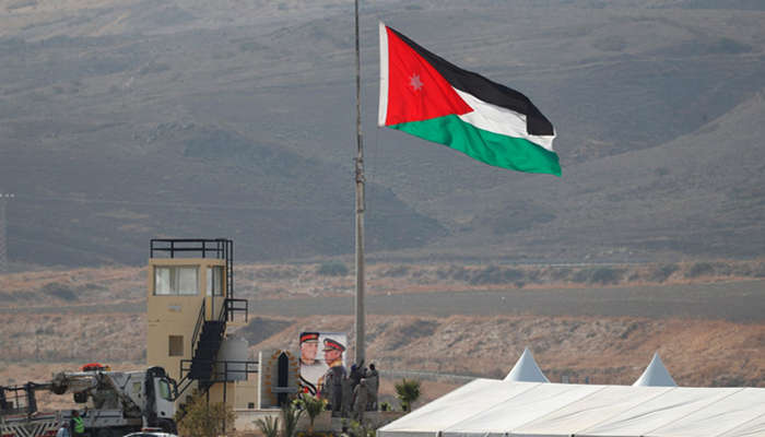 The image shows Jordanian flag lifted at border with Israel. — Reuters/File