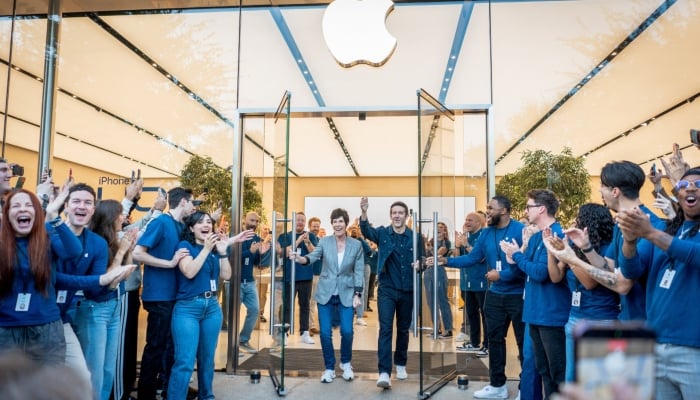 Deirdre O’Brien, Apple Senior Vice President of Retail, and John Ternus, CEO of Apple, greet customers who came to purchase the new foldable iPhone Duo on the launch day at the Apple store in Austin, Texas, US, October 23, 2026. — Reuters
