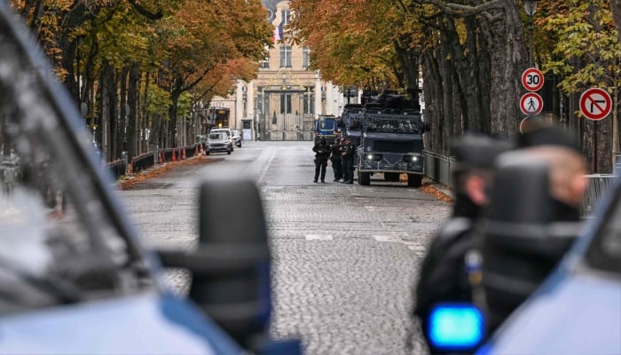 This photograph shows French gendarmes standing next to multipurpose intervention vehicles (VIPG) Centaure of the French gendarmerie on a blocked street near the Elysee Presidential Palace and the French Interior Ministry, in Paris on October 24, 2026. — AFP