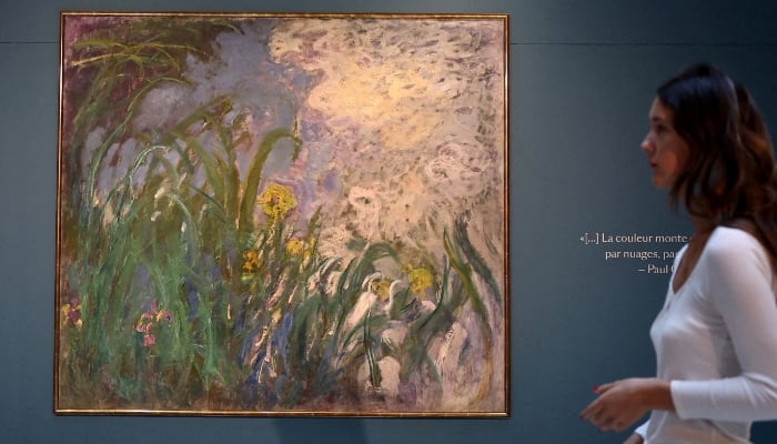 A visitor walks past the painting Iris, 1924-1925 by French painter Claude Monet (1840-1926) during the presentation of 28 art works from the Schlumberger Collection ahead of the auction at Sothebys auction house in Paris, France, September 17, 2026. — Reuters