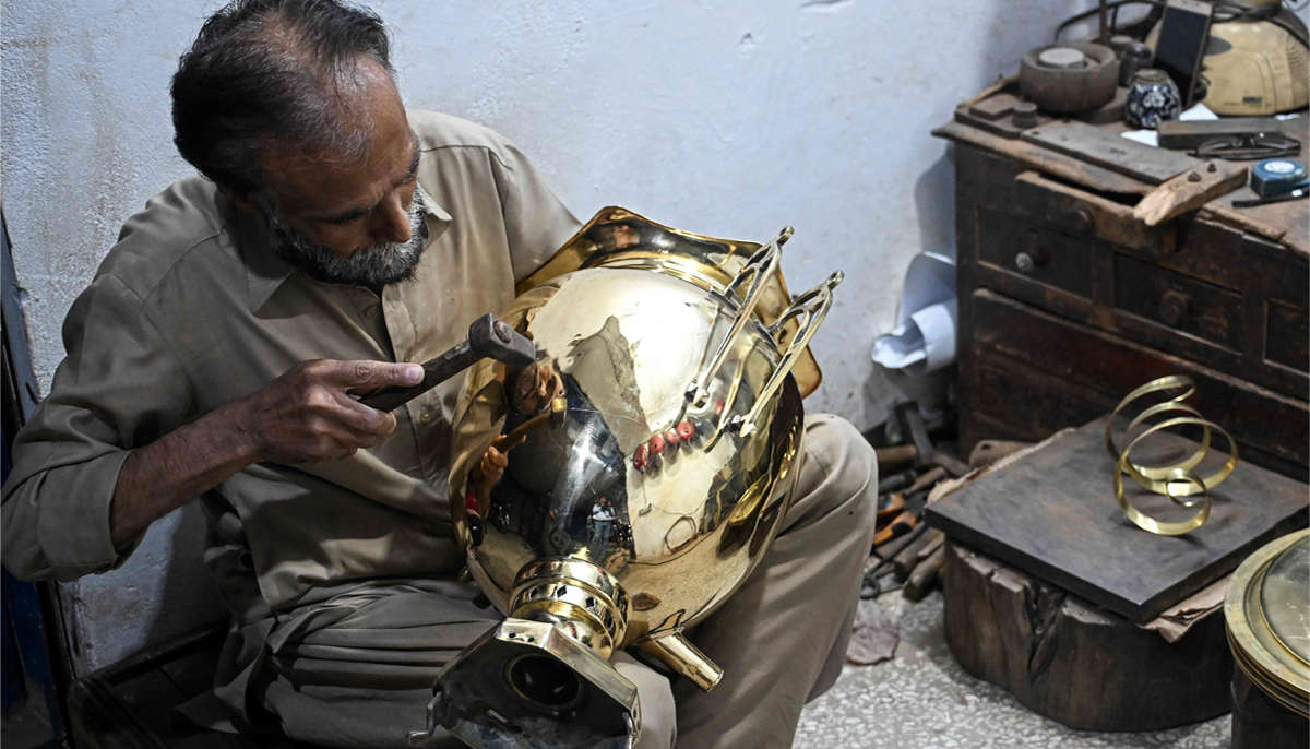 Antique dealer Shakeel Ahmed works on an artefact at his restoration workshop in Rawalpindi on October 20, 2026.— AFP