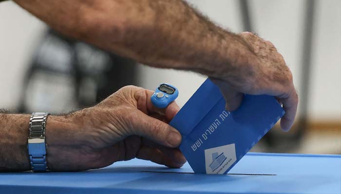 A man casts his ballot to vote at a polling station in the Arab-Israeli town of Umm al-Fahm on October 27, 2026. — AFP