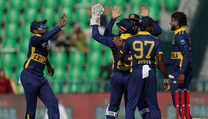 Sri Lankan players celebrate after taking a wicket during the fifth match of the ODI tri-series against Pakistan at the Gaddafi Stadium in Lahore on October 27, 2026. — PCB