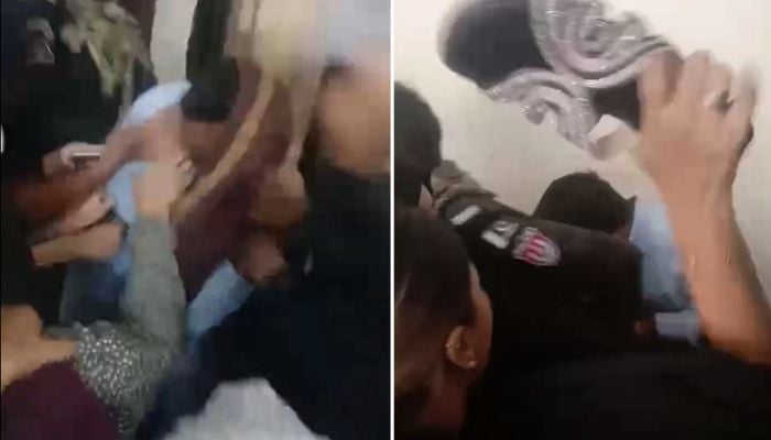 Women slap and beat a suspect with slippers during his court appearance over an alleged mobile phone snatching incident in Karachi. — Geo News