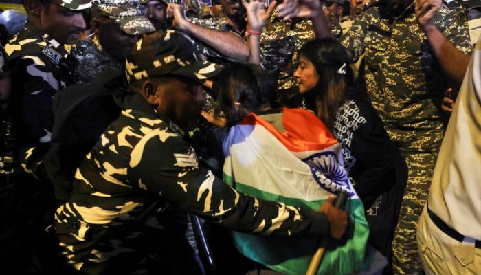 Security personnel detain a protester during a flag rally organised by the Cockroach Janta Party (CJP), demanding the resignation of Indias Chief Election Commissioner Gyanesh Kumar, in New Delhi, India, October 16, 2026. — Reuters